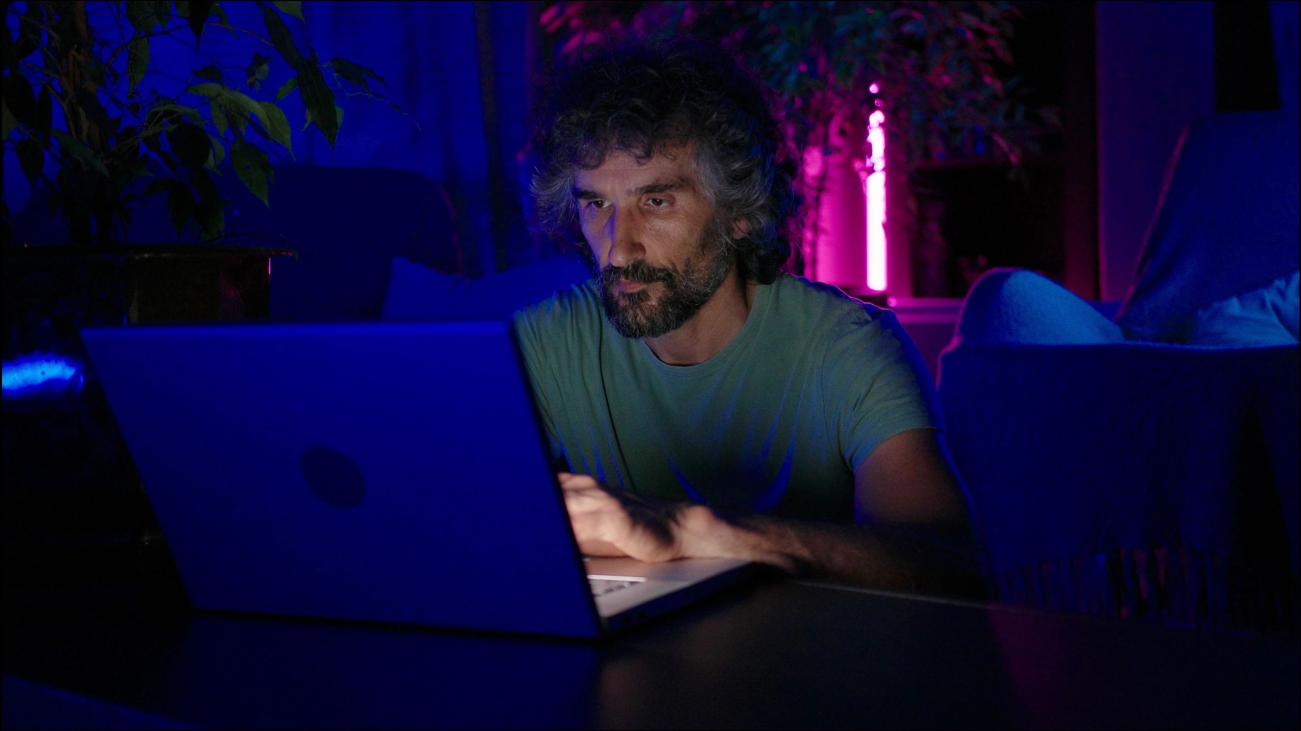 Professional working on a laptop in a calm night-time workspace