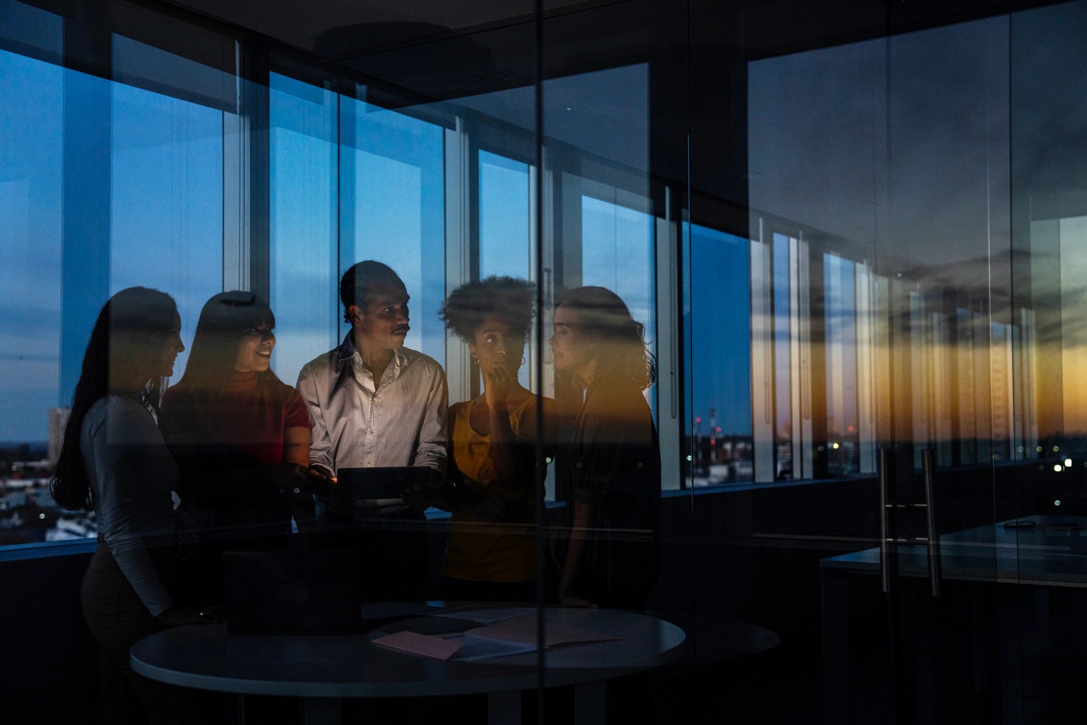 Team collaborating in a dark modern workspace