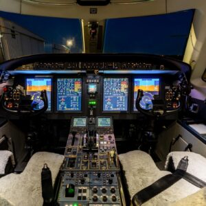 Cockpit of Private Jet with Instrument Panel Lit Up