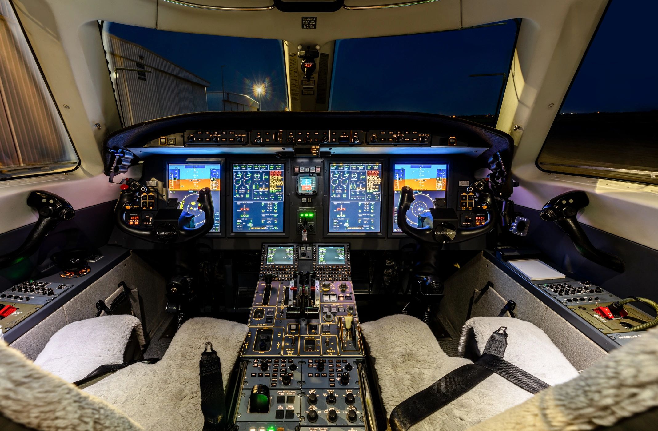 Cockpit of Private Jet with Instrument Panel Lit Up